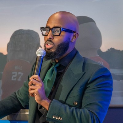 Abdie Mohamed speaking into a microphone
